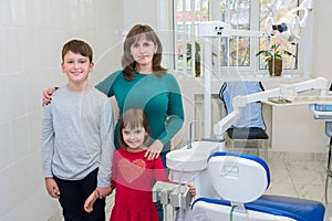 A happy family in a dentistÃ¢â¬â¢s office. Medicine, dentistry and health care photo